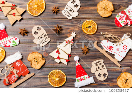 Top view of Christmas toys on wooden background. New Year ornament. Holiday concept 109858427