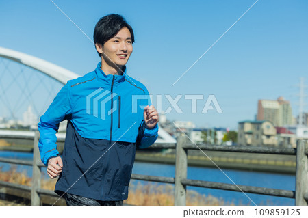 A man running on the riverbed A man running on the riverbed 109859125