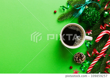 Delicious fresh festive morning coffee in a ceramic cup with little wrapped gifts, ornament and xmas toy. Cup of coffee and new year toys 109859257