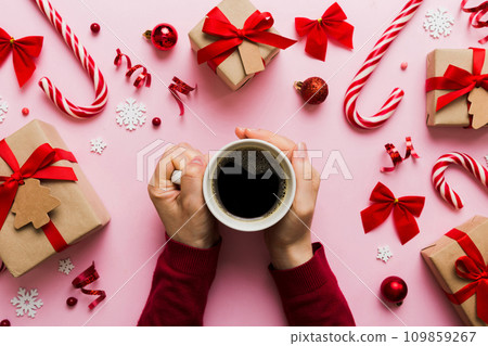 Woman holding cup of coffee. Woman hands holding a mug with hot coffee. Winter and Christmas time concept Woman holding cup of coffee. Woman hands holding a mug with hot coffee. Winter and Christmas time concept 109859267