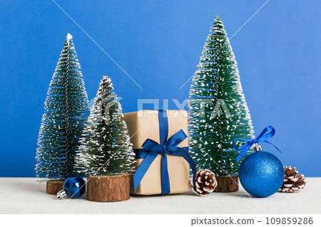 Christmas composition. craft Gift box, small tree, branches and craft DIY decorations on white background. New year concept. Christmas home decoration Flat lay, top view, copy space 109859286