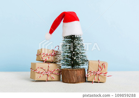 Christmas composition. Gifts, small tree, branches and craft DIY decorations on white background. New year concept. Christmas home decoration Flat lay, top view, copy space Christmas composition. Gifts, small tree, branches and craft DIY decorations on white background. New year concept. Christmas home decoration Flat lay, top view, copy space 109859288