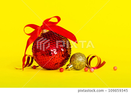 Christmas ball on colored background. decoration bauble with ribbon bow with copy space Christmas ball on colored background. decoration bauble with ribbon bow with copy space 109859345