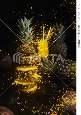 Pineapple flying in air cut in slices with juice splash Pineapple flying in air cut in slices with juice splash 109859529