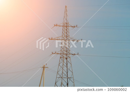 High voltage towers with sky background. Power line support with wires for electricity transmission. High voltage grid tower with wire cable at distribution station. Energy industry, energy saving 109860002