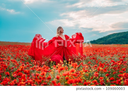 Woman poppy field red dress. Happy woman in a long red dress in a beautiful large poppy field. Blond stands with her back posing on a large field of red poppies Woman poppy field red dress. Happy woman in a long red dress in a beautiful large poppy field. Blond stands with her back posing on a large field of red poppies 109860003