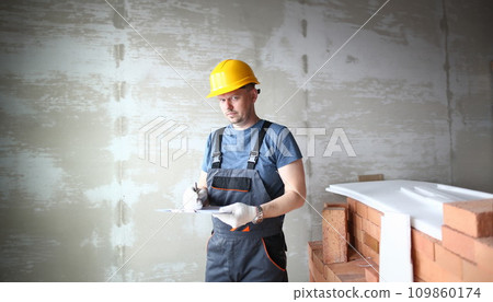 Serious man in hardhat 109860174