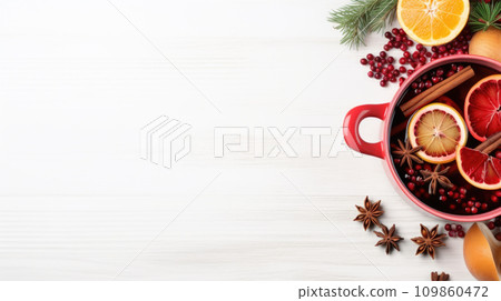 Hot mulled wine with fruits and spices winter cocktail on white wooden table 109860472