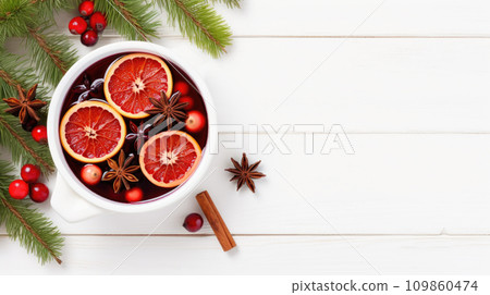 Hot mulled wine with fruits and spices winter cocktail on white wooden table 109860474