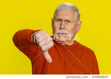 Upset grandfather man showing thumbs down gesture disapproval dissatisfied dislike negative feedback 109860697