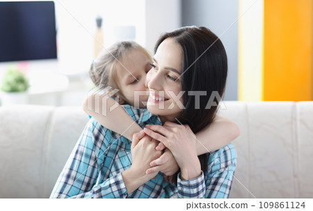 Little girl hugging young woman at home Little girl hugging young woman at home 109861124
