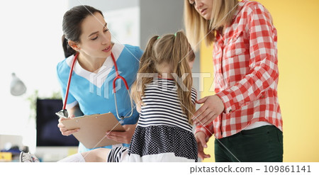 Little girl holding her neck at pediatrician doctor appointment 109861141