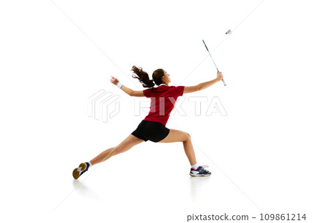 Badminton female athlete in motion, displaying attack and defense skills with finesse against white studio background. Concept of sport. 109861214