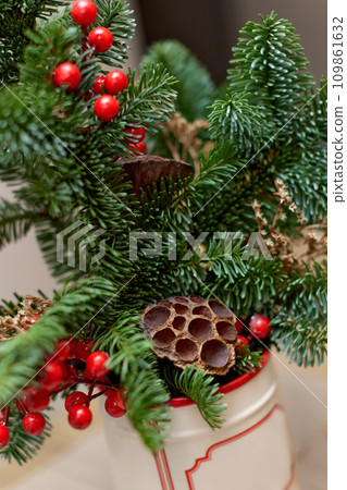 Homemade christmas decorations on table. Christmas bouquet in vase 109861632