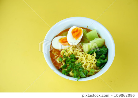 Indonesian home made Noodles with served Boiled Egg, chicken and vegetables. Indonesian home made Noodles with served Boiled Egg, chicken and vegetables. 109862096