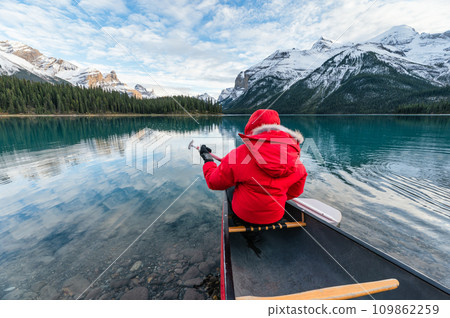Male tourist canoeing in Spirit Island on Maligne Lake at Jasper national park, Canada 109862259