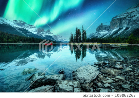 Spirit Island with aurora borealis glowing in the night sky on Maligne Lake at Jasper national park, Canada 109862262