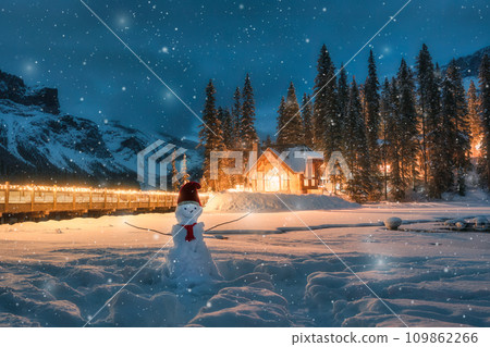 Emerald Lake with wooden cottage and snowman in falling snow at Yoho national park, Canada Emerald Lake with wooden cottage and snowman in falling snow at Yoho national park, Canada 109862266