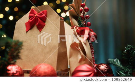 Christmas Gift Brown Bags Against Tree Christmas Gift Brown Bags Against Tree 109862649
