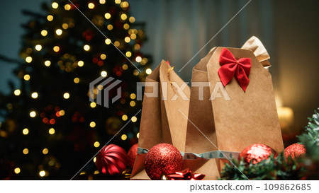 Christmas Gift Brown Bags Against Tree Christmas Gift Brown Bags Against Tree 109862685