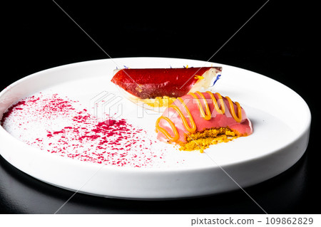 Italian Sicilian cannolo dessert closeup on white plate macro with crust and ricotta cheese Italian Sicilian cannolo dessert closeup on white plate macro with crust and ricotta cheese 109862829