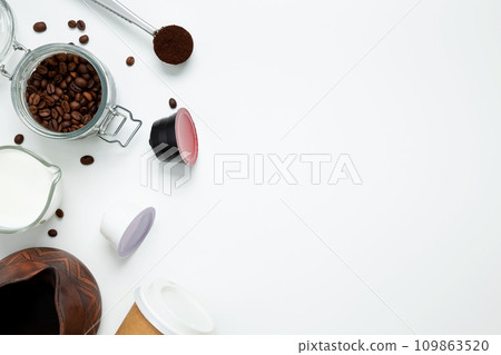 Ingredients for making coffee. Making coffee in clay cezve with milk or coffee machine capsules. Coffee making concept. Flat Lay. Top view. Copy space Ingredients for making coffee. Making coffee in clay cezve with milk or coffee machine capsules. Coffee making concept. Flat Lay. Top view. Copy space 109863520