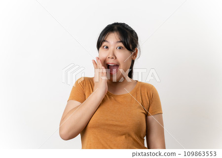 The pretty Asian young woman with surprise and shocked facial expression standing on a white background. The pretty Asian young woman with surprise and shocked facial expression standing on a white background. 109863553