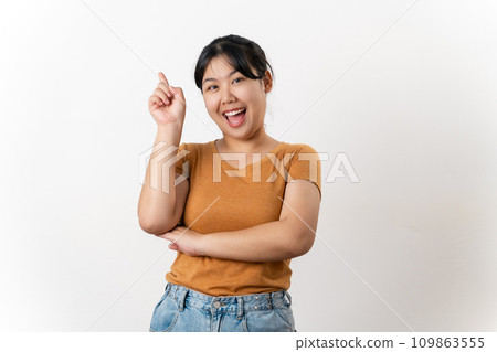 The cheerful young Asian woman has great thought, finding inspiration or solutions to solve a problem. pointing finger up standing on white background. 109863555