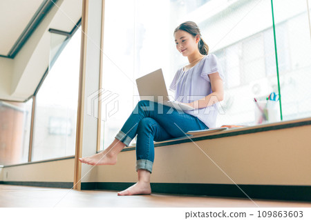Minimalist woman operating a computer Minimalist woman operating a computer 109863603