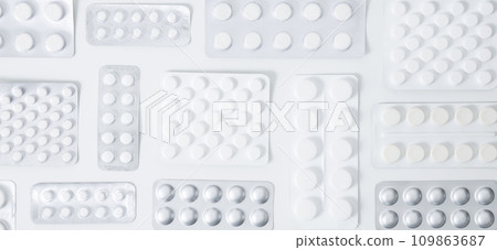 Various tablets and capsules in blisters on white background. Concept of healthcare and medicine. Top view Various tablets and capsules in blisters on white background. Concept of healthcare and medicine. Top view 109863687