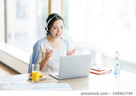 A woman having a web conference at home A woman having a web conference at home 109863794