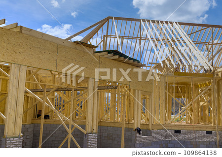 Construction of wooden framework for new house under construction Construction of wooden framework for new house under construction 109864138