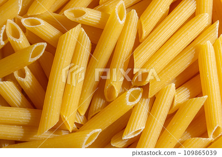 Uncooked Penne Rigate Pasta Background 109865039