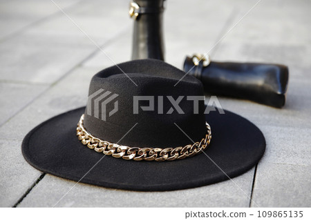 Stylish black hat with leather boots in the background in the street Stylish black hat with leather boots in the background in the street 109865135