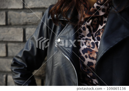 Woman wearing Rock'n'roll leather jacket. Closeup shot. Selective foucus on the details Woman wearing Rock'n'roll leather jacket. Closeup shot. Selective foucus on the details 109865136