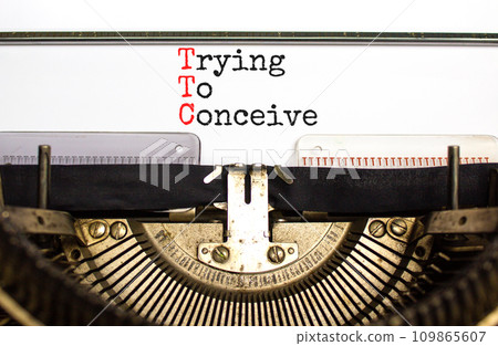 TTC trying to conceive symbol. Concept words TTC trying to conceive typed on retro old typewriter on a beautiful white paper background. Medical and TTC trying to conceive concept. Copy space. TTC trying to conceive symbol. Concept words TTC trying to conceive typed on retro old typewriter on a beautiful white paper background. Medical and TTC trying to conceive concept. Copy space. 109865607