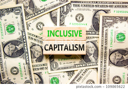 Inclusive capitalism symbol. Concept words Inclusive capitalism on beautiful wooden blocks. Dollar bills. Beautiful background from dollar bills. Business inclusive capitalism concept. Copy space. 109865622