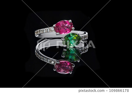 beautiful gold ring with precious stones ruby, chrysoprase, diamonds on a black background beautiful gold ring with precious stones ruby, chrysoprase, diamonds on a black background 109866178