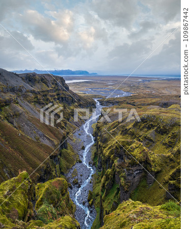 Beautiful autumn Mulagljufur Canyon, Iceland. It is located not far from Ring Road and Fjallsarlon glacier with Breidarlon ice lagoon at the south end of Vatnajokull icecap and Oaefajokull volcano. Beautiful autumn Mulagljufur Canyon, Iceland. It is located not far from Ring Road and Fjallsarlon glacier with Breidarlon ice lagoon at the south end of Vatnajokull icecap and Oaefajokull volcano. 109867442