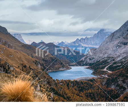 Autumn Dolomites mountain view from hiking path betwen Pordoi Pass and Fedaia Lake, Italy. Autumn Dolomites mountain view from hiking path betwen Pordoi Pass and Fedaia Lake, Italy. 109867591