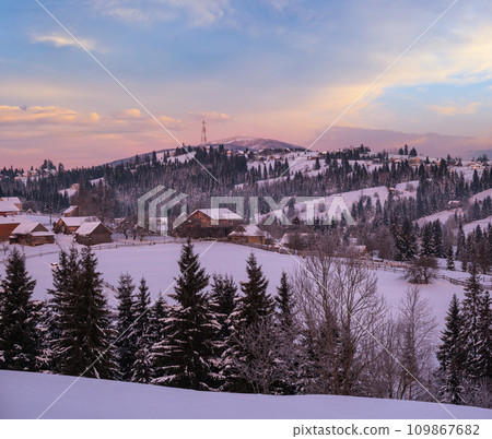 Small and quiet alpine village and winter sunrise snowy mountains around, Voronenko, Carpathian, Ukraine. Small and quiet alpine village and winter sunrise snowy mountains around, Voronenko, Carpathian, Ukraine. 109867682