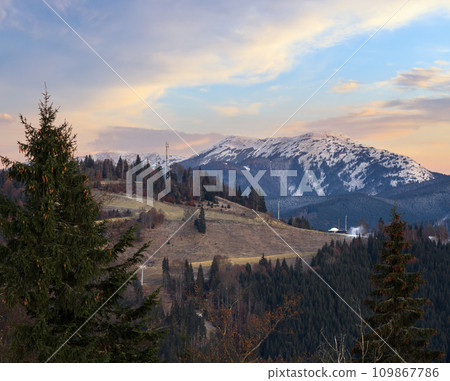 Picturesque sunrise above late autumn mountain countryside.  Ukraine, Carpathian Mountains. Peaceful traveling, seasonal, nature and countryside beauty concept scene. 109867786