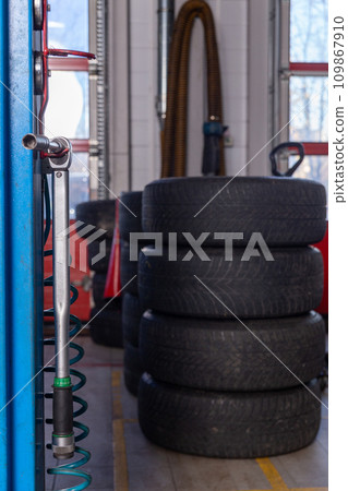 A set of tires for seasonal replacement near the lift in the tire workshop. 109867910