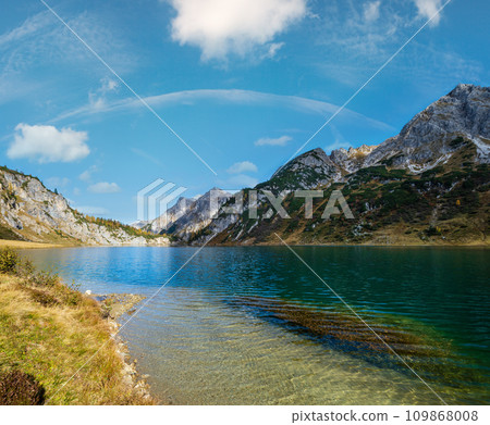 Sunny autumn alpine Tappenkarsee lake and rocky mountains above, Kleinarl, Land Salzburg, Austria. Sunny autumn alpine Tappenkarsee lake and rocky mountains above, Kleinarl, Land Salzburg, Austria. 109868008