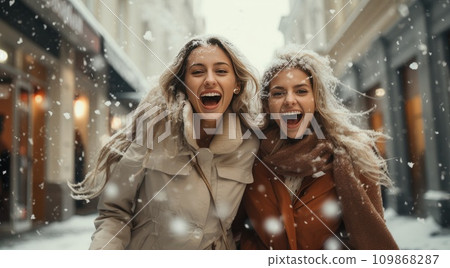 two women are in the middle of the rain and snow holding shopping bags two women are in the middle of the rain and snow holding shopping bags 109868287
