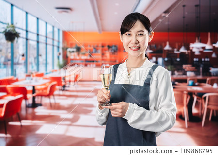 Woman serving sparkling wine at a restaurant 109868795