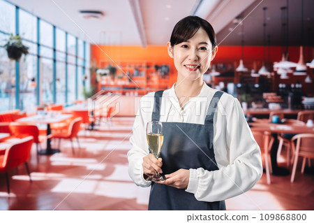 Woman serving sparkling wine at a restaurant Woman serving sparkling wine at a restaurant 109868800