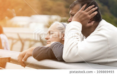 An elderly retired couple, a man and a woman walks and spends time together. An elderly retired couple, a man and a woman walks and spends time together. 109869493