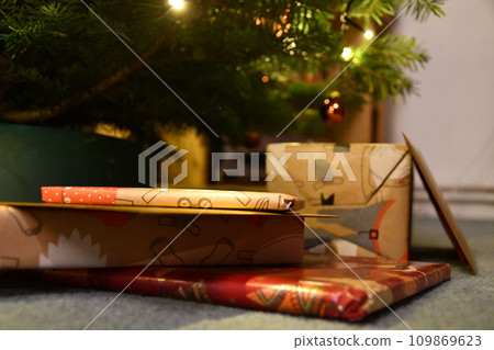 Beautifully wrapped gifts under a Christmas tree in Germany Beautifully wrapped gifts under a Christmas tree in Germany 109869623
