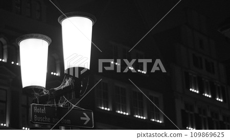 Grayscale shot of an old street light in icy night in Muenster, Germany Grayscale shot of an old street light in icy night in Muenster, Germany 109869625